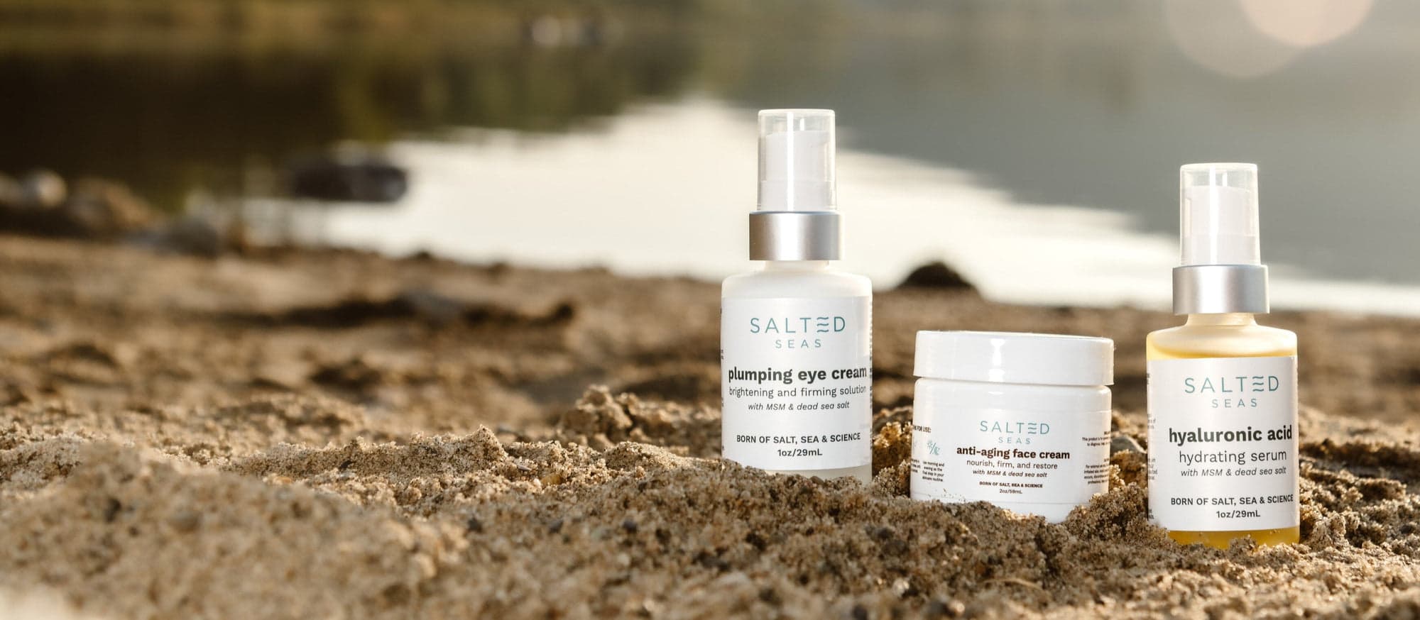 Salted Seas skincare products displayed on a sunlit beach